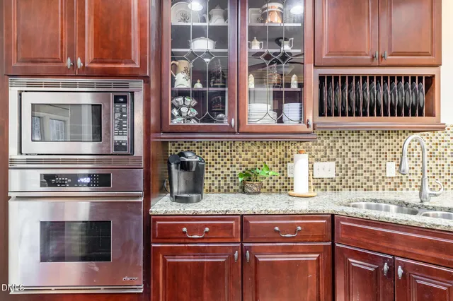 a kitchen with stainless steel appliances granite countertop a stove and a microwave
