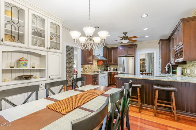 a large kitchen with a table and chairs