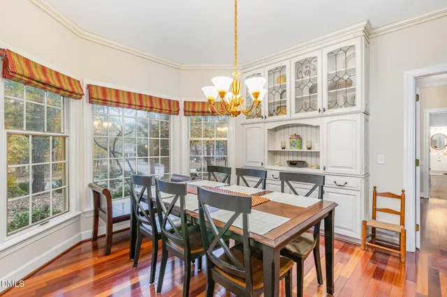 a view of a dining room with furniture large windows and wooden floor