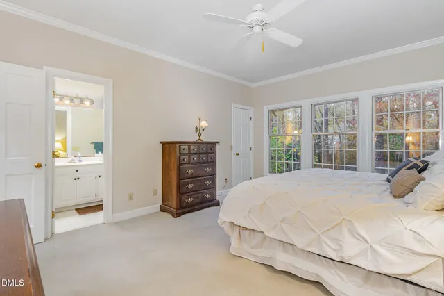 a bedroom with a bed and dresser with mirror