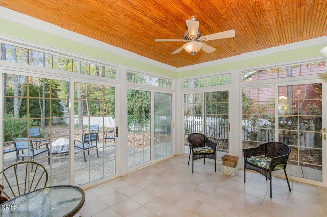 a view of a house with backyard sitting area and garden