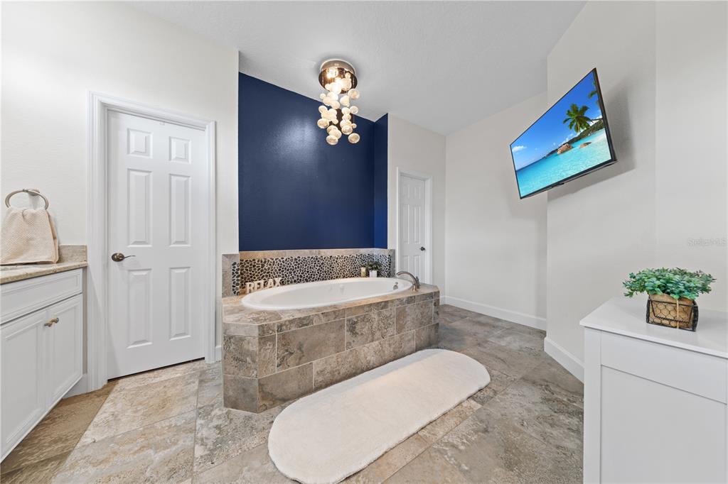 16948 Deer Island Road Tavares, FL 32778 - Photo 19 of 67 a bathroom with a toilet a sink and mirror