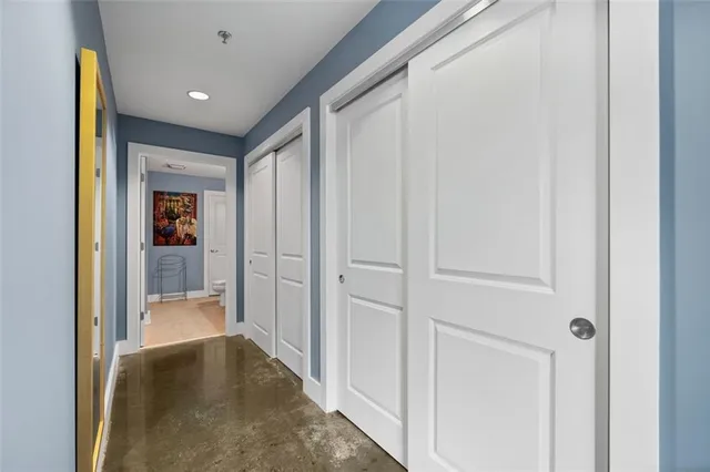 a bathroom with a granite countertop sink mirror vanity and toilet