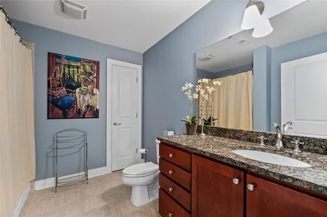 a bathroom with a sink mirror and toilet
