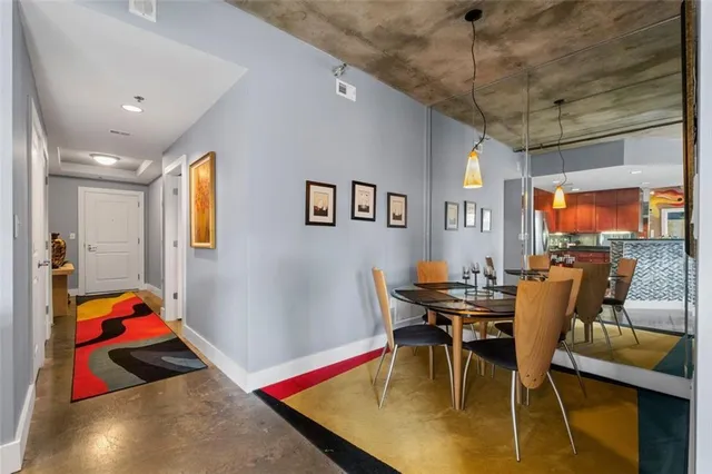 a view of a dining room with furniture and a chandelier