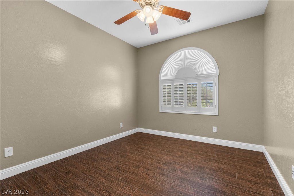 2627 Dirleton Place Henderson, NV 89044 - Photo 24 of 42 Hardwood look tile floors and a detailed ceiling fan enhance this cozy room, offering comfort and style.