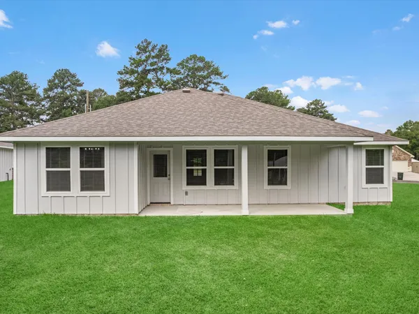 a front view of a house with a garden and yard