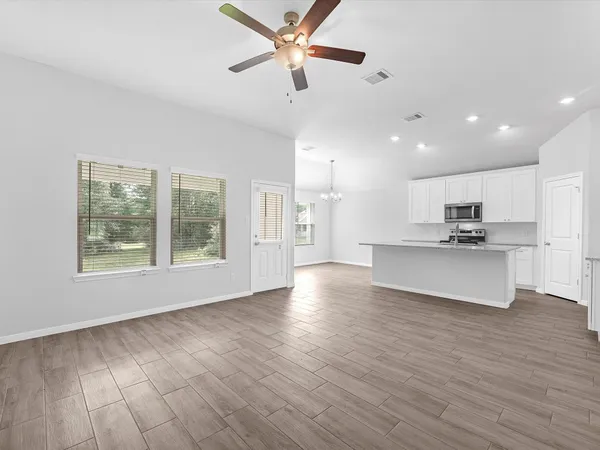 a view of kitchen with cabinets and wooden floor