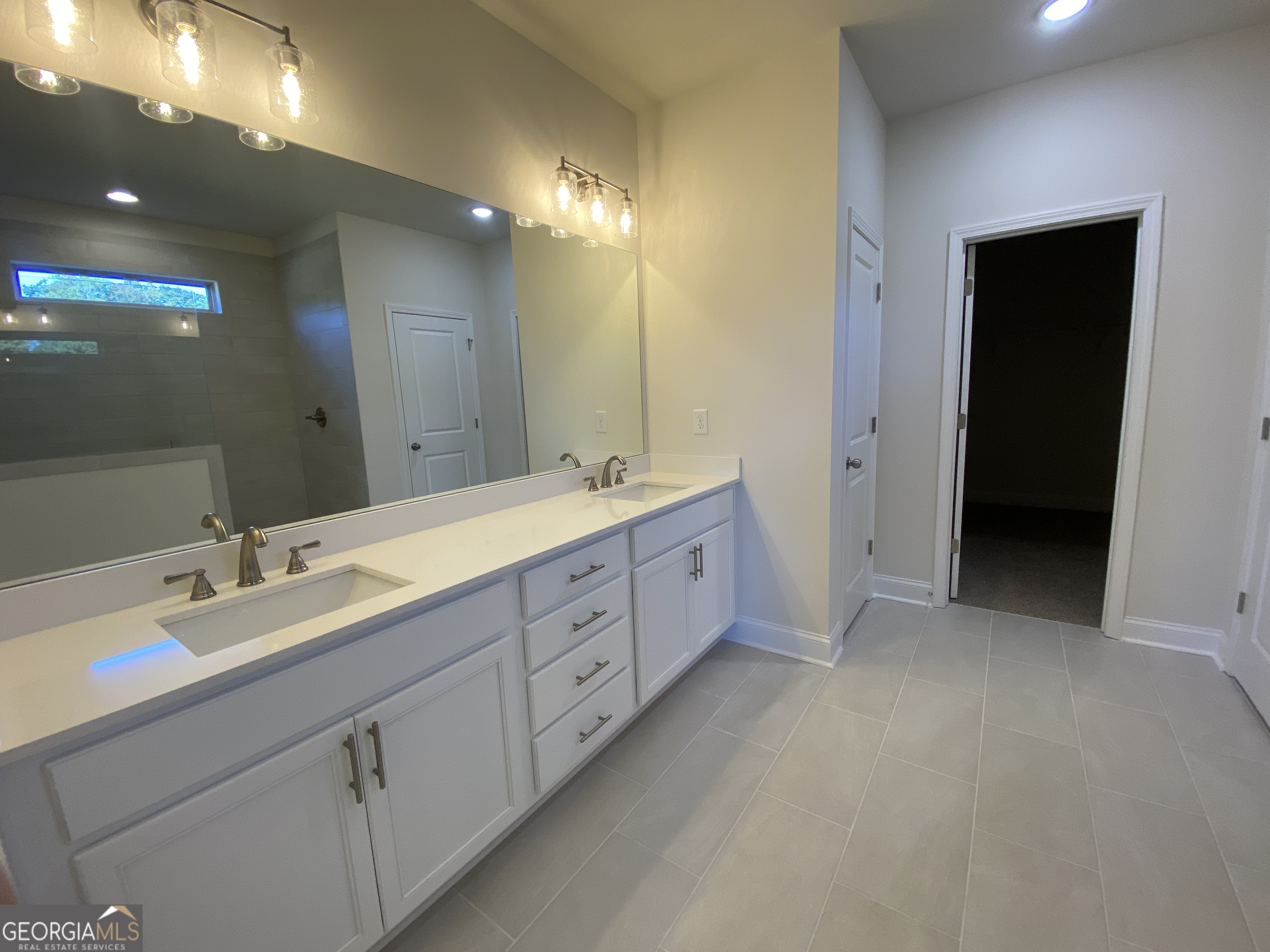 174 Oakdale Road, Unit 34 Jefferson, GA 30549 - Photo 35 of 64 Primary bathroom has double vanity sinks set at gentlmen's height and topped with quartz.
