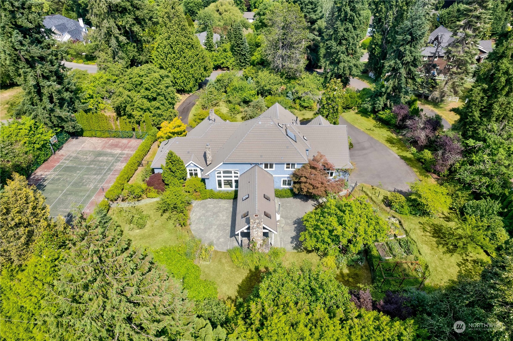 an aerial view of a house with a yard and lake view