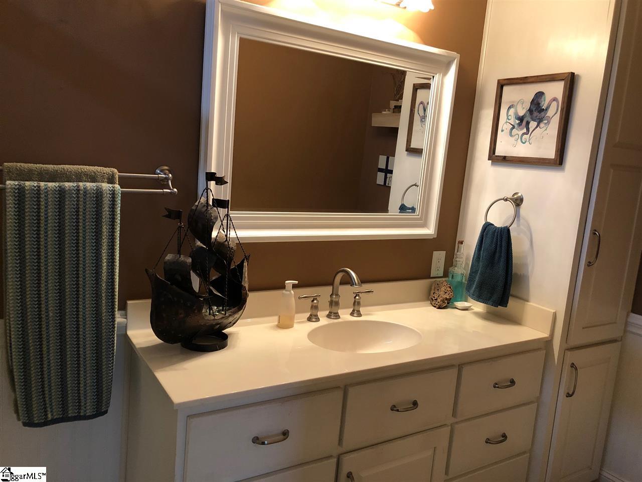 Updated master bathroom with tons of storage.