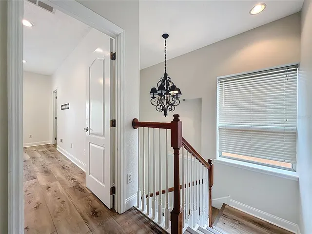 a spacious bedroom with a large bed and a wooden floor