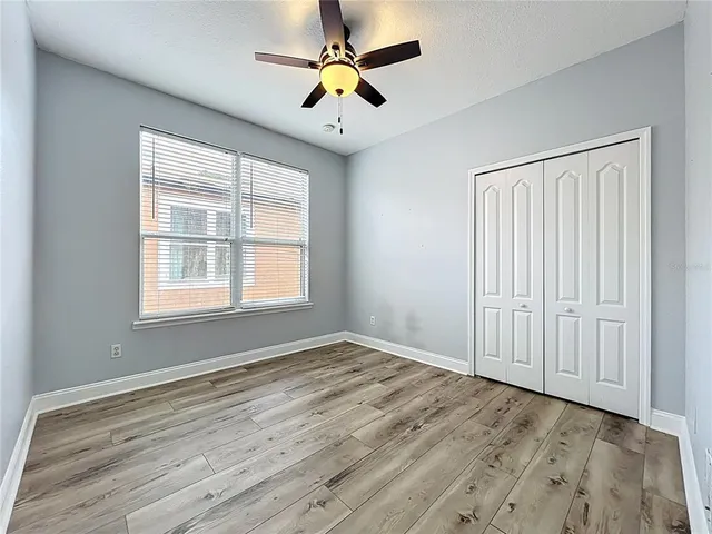 a view of a house with backyard and a tree