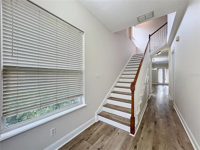 a view of a staircase and wooden floor
