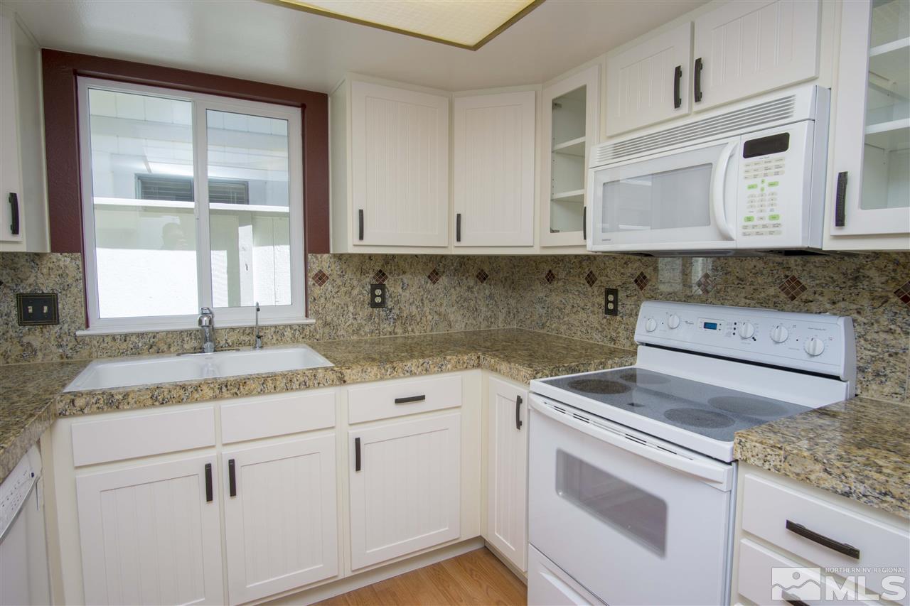 1245 Searchlite Court Reno, NV 89503 - Photo 11 of 26 a kitchen with granite countertop cabinets stainless steel appliances and a sink