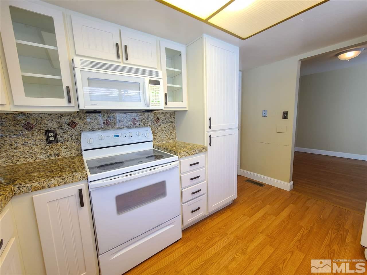 1245 Searchlite Court Reno, NV 89503 - Photo 12 of 26 a kitchen with cabinets appliances and wooden floor