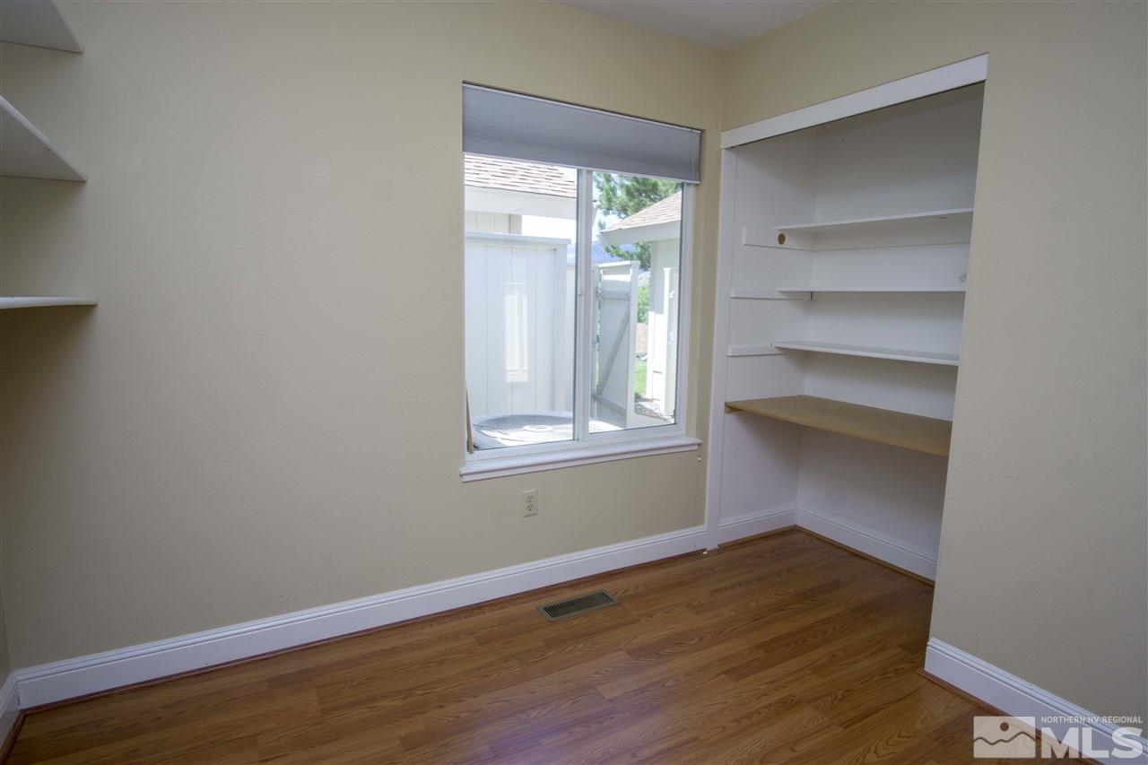 1245 Searchlite Court Reno, NV 89503 - Photo 13 of 26 a view of an empty room with wooden floor and a window