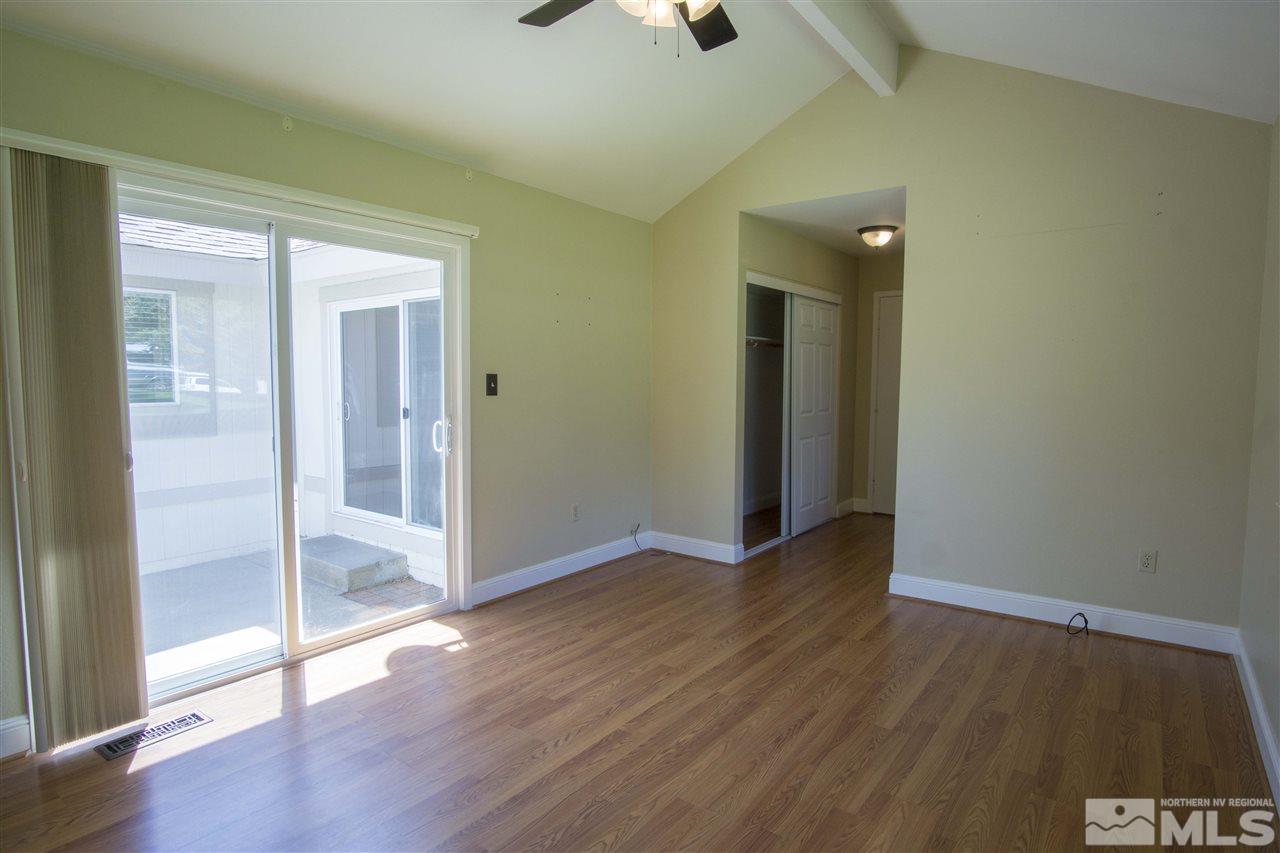 1245 Searchlite Court Reno, NV 89503 - Photo 18 of 26 an empty room with wooden floor and a carpet