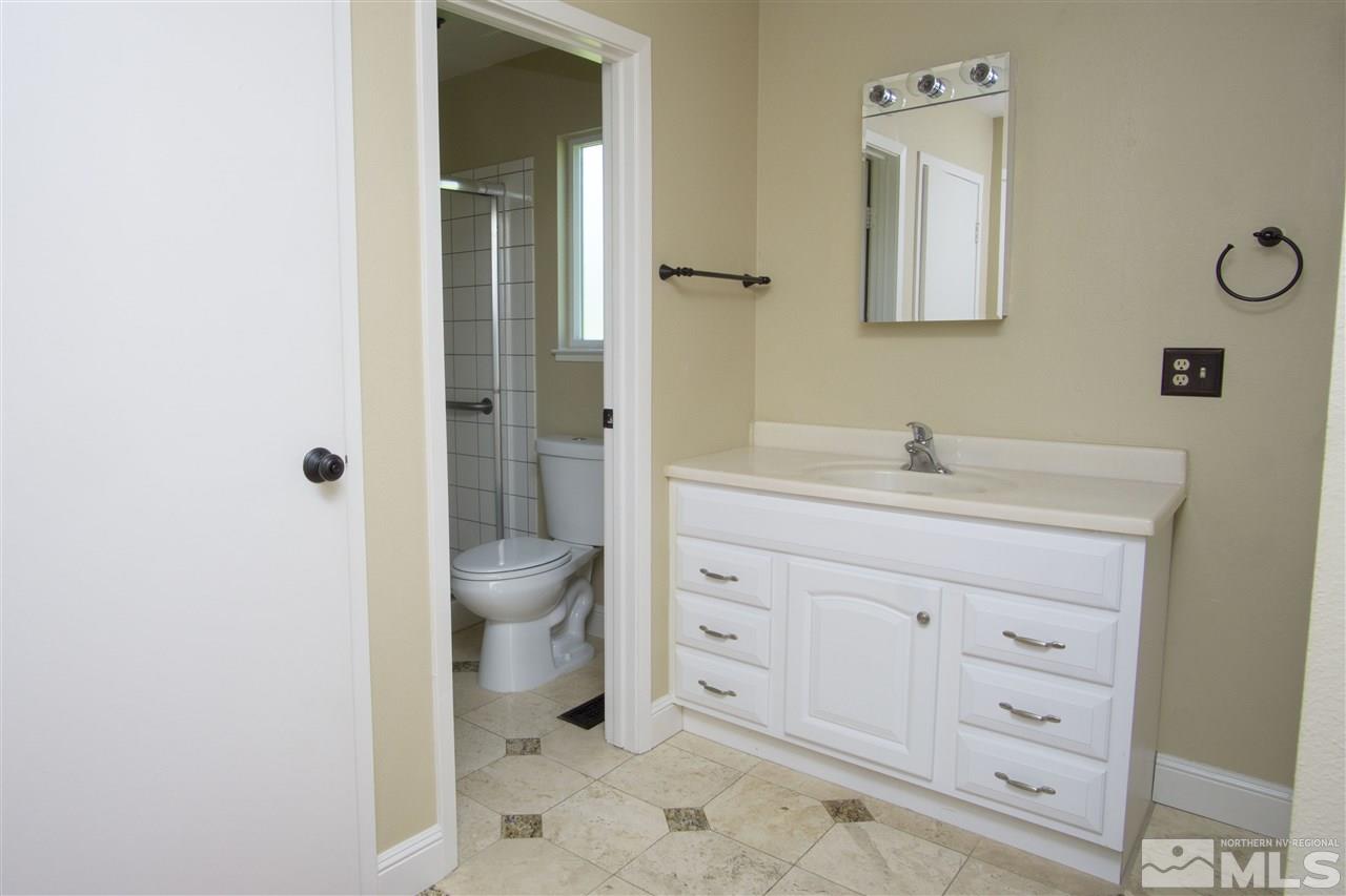 1245 Searchlite Court Reno, NV 89503 - Photo 19 of 26 a bathroom with a sink a toilet and shower