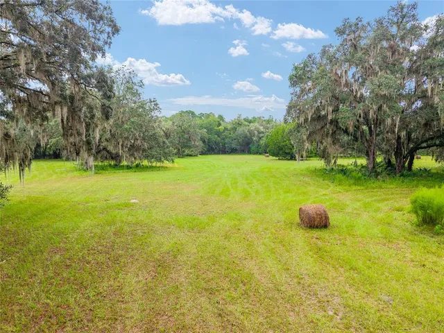 a swimming pool with an outdoor space and seating