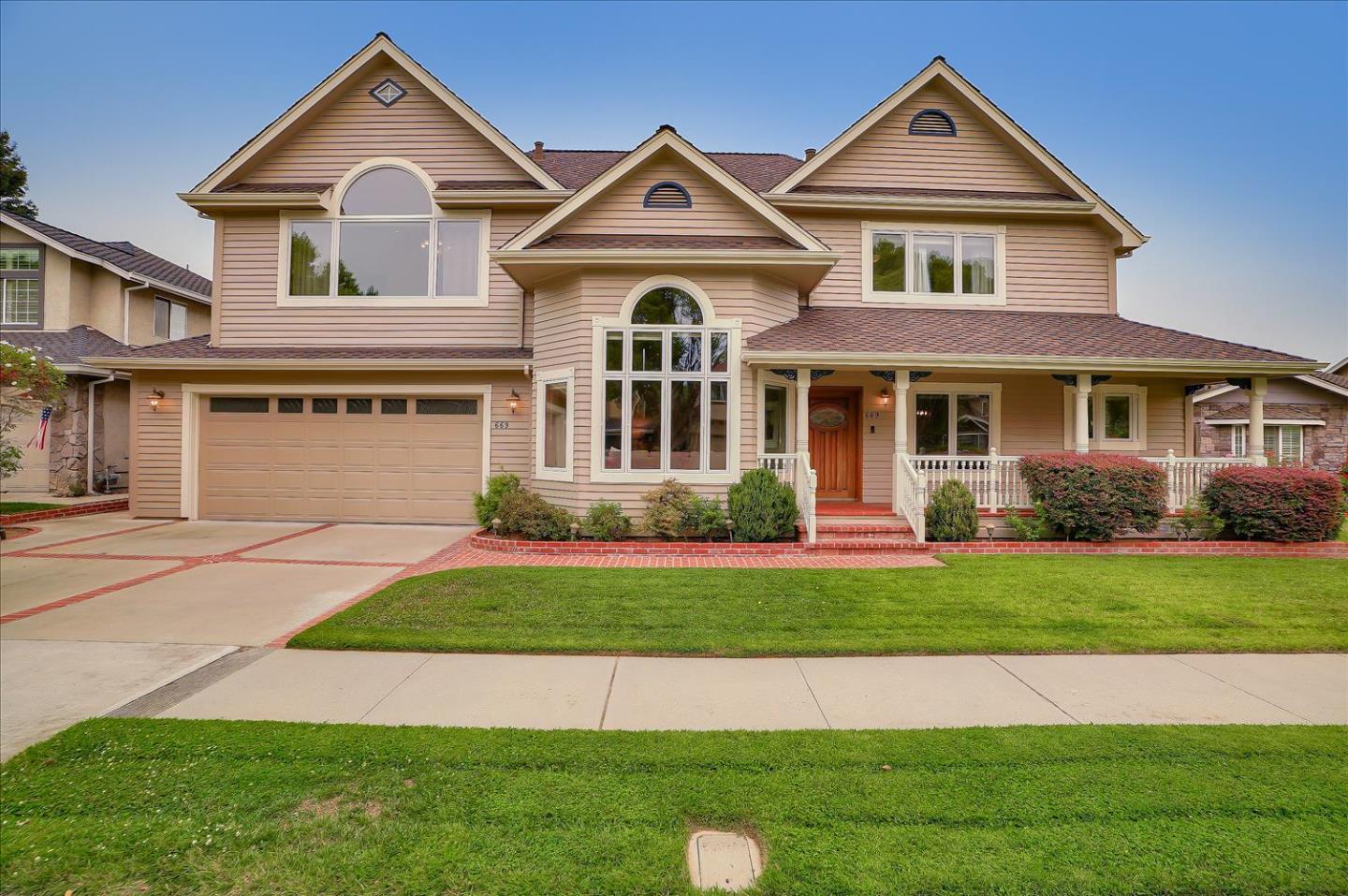 669 Regas Drive Campbell, CA 95008 - Photo 1 of 59 a front view of a house with a yard and garage