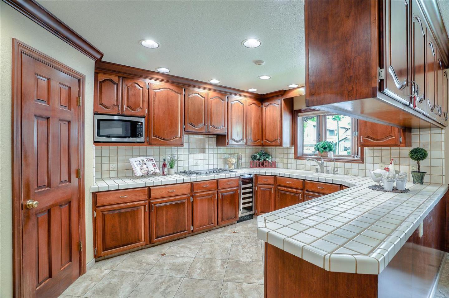 669 Regas Drive Campbell, CA 95008 - Photo 13 of 59 a kitchen with granite countertop a sink dishwasher stove and cabinets