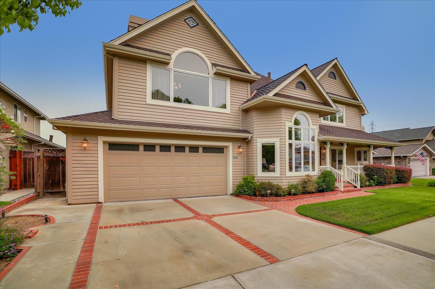 669 Regas Drive Campbell, CA 95008 - Photo 2 of 59 a front view of a house with a yard and garage