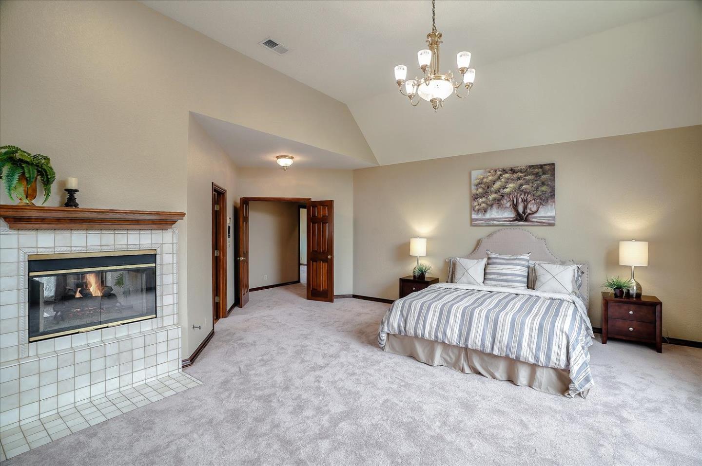 669 Regas Drive Campbell, CA 95008 - Photo 25 of 59 a spacious bedroom with a bed and a fireplace