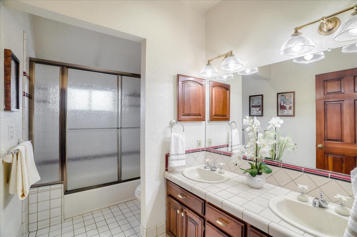 669 Regas Drive Campbell, CA 95008 - Photo 45 of 59 a bathroom with a granite countertop sink a large mirror and a shower