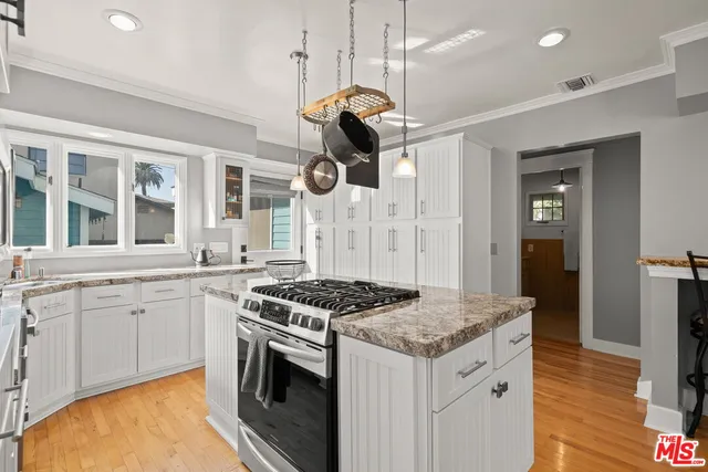 a kitchen with stainless steel appliances granite countertop a stove and a refrigerator