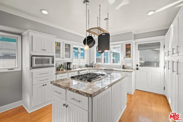 a kitchen with stainless steel appliances granite countertop a stove and a sink