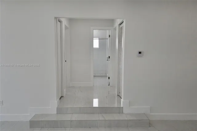 an empty room with windows and closet