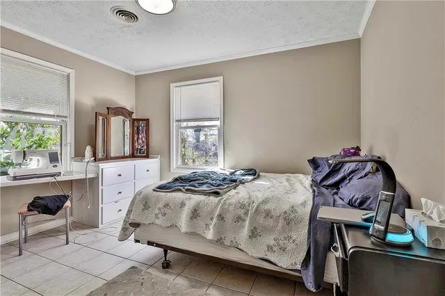 a bed room with a bed and a chair