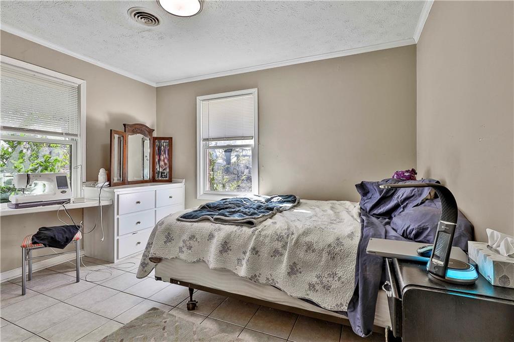 8420 Cleckler Road Palmetto, GA 30268 - Photo 19 of 51 a bedroom with a bed a table and chair