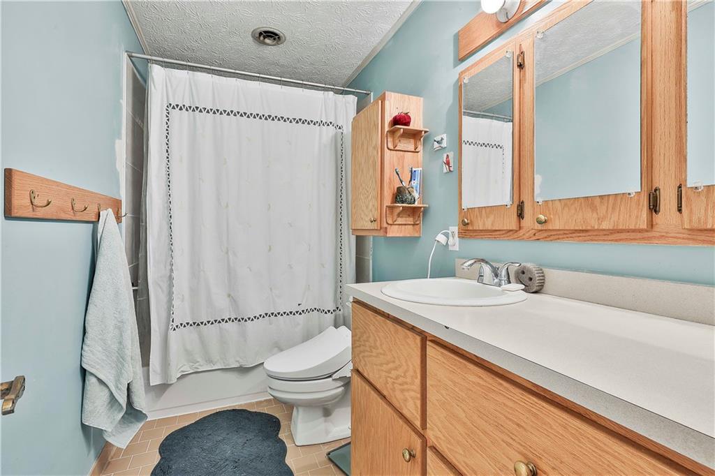 8420 Cleckler Road Palmetto, GA 30268 - Photo 21 of 51 a bathroom with a sink toilet and shower