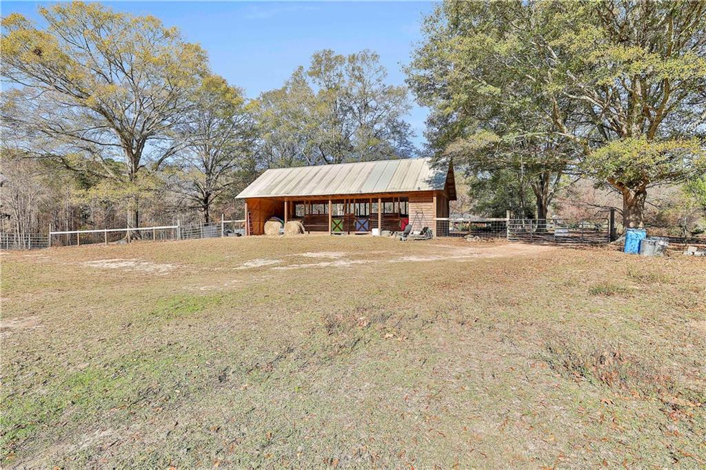 8420 Cleckler Road Palmetto, GA 30268 - Photo 37 of 51 a view of a street with a building and trees in the background
