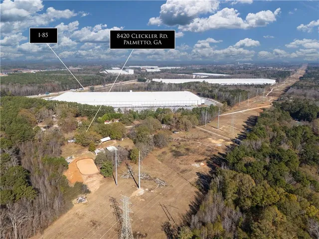 a view of a house with a yard and large tree