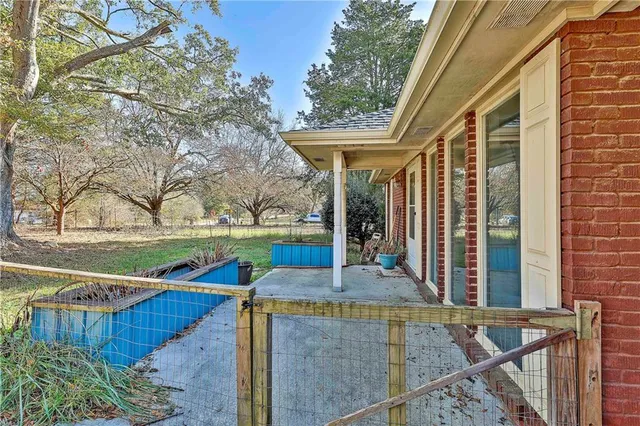 a view of a porch with a dining table and chairs