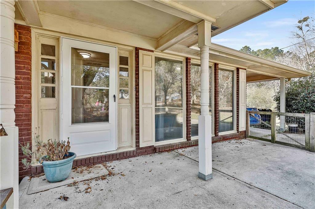 8420 Cleckler Road Palmetto, GA 30268 - Photo 9 of 51 a view of a porch with a dining table and chairs