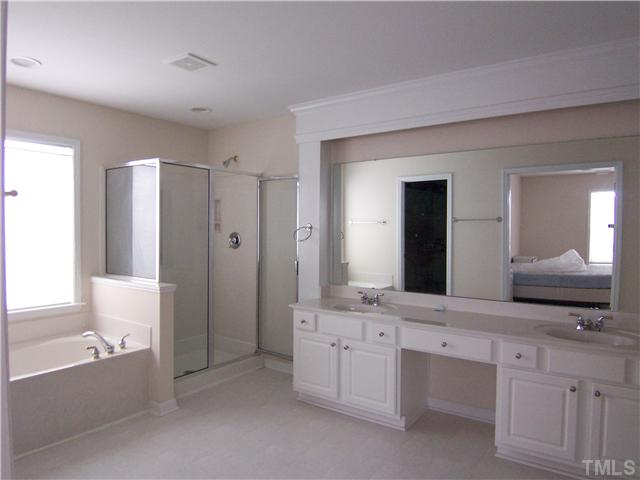 7605 Derek Drive Raleigh, NC 27613 - Photo 14 of 18 a bathroom with a double vanity sink mirror and bathtub