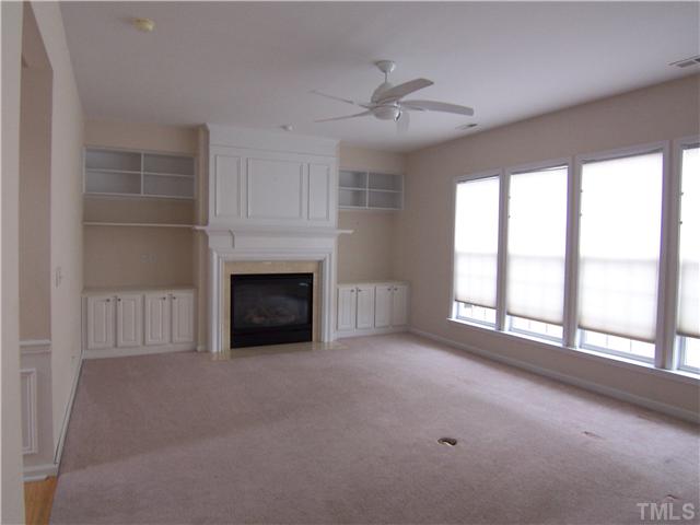 7605 Derek Drive Raleigh, NC 27613 - Photo 3 of 18 a view of an empty room with a fireplace and a window