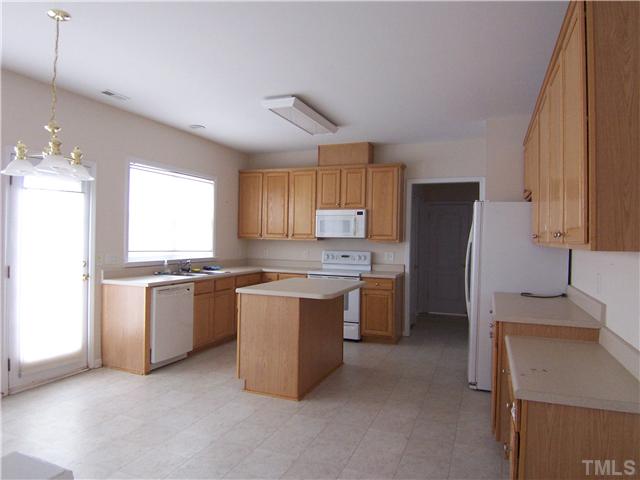 7605 Derek Drive Raleigh, NC 27613 - Photo 4 of 18 a kitchen with a refrigerator and a sink
