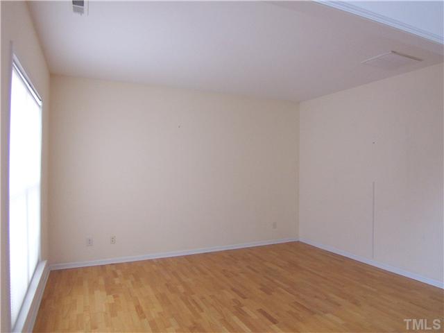 7605 Derek Drive Raleigh, NC 27613 - Photo 6 of 18 a view of an empty room and window