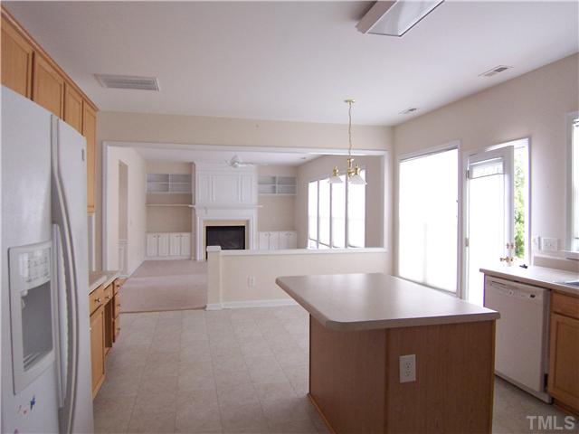 7605 Derek Drive Raleigh, NC 27613 - Photo 7 of 18 a kitchen with refrigerator and window