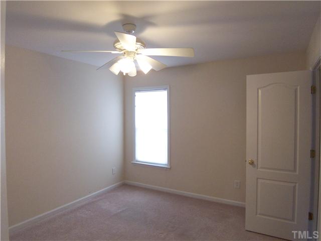 7605 Derek Drive Raleigh, NC 27613 - Photo 10 of 18 an empty room with windows and fan