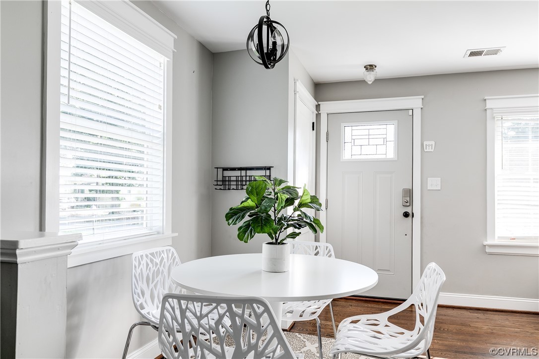 4301 Norborne Road Richmond, VA 23234 - Photo 12 of 29 a dining room with furniture potted plants and wooden floor