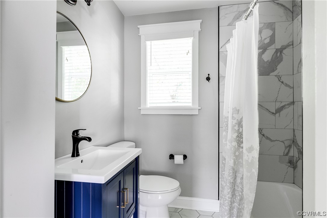 4301 Norborne Road Richmond, VA 23234 - Photo 19 of 29 a bathroom with a toilet sink and a mirror