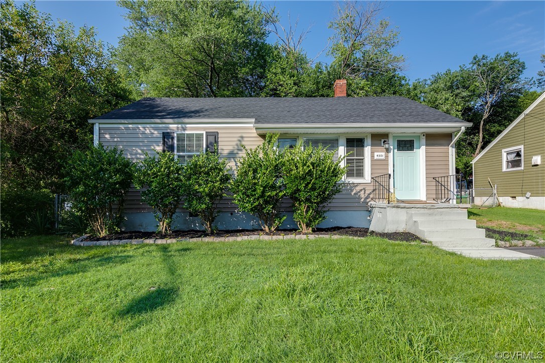4301 Norborne Road Richmond, VA 23234 - Photo 2 of 29 a view of a yard in front of a house with plants and large tree