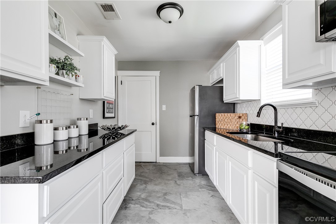 4301 Norborne Road Richmond, VA 23234 - Photo 7 of 29 a kitchen with stainless steel appliances a sink stove and refrigerator