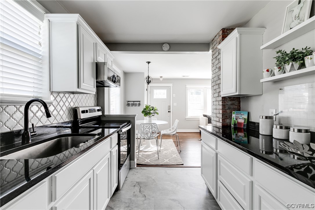 4301 Norborne Road Richmond, VA 23234 - Photo 9 of 29 a kitchen with granite countertop a sink and cabinets
